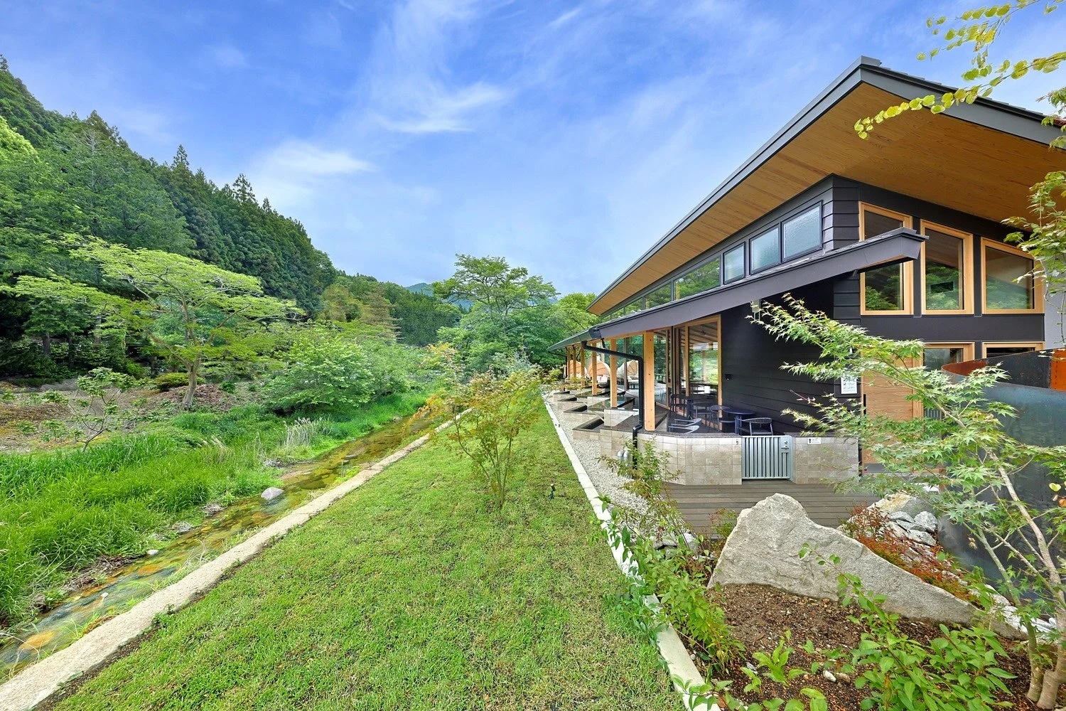 豊かな自然と小川に囲まれた現代的な建物